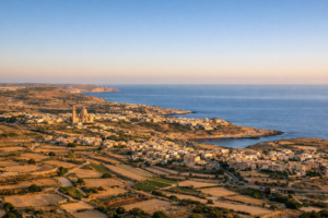 Island of Gozo Malta coastline at golden hour with limestone countryside and Mediterranean sea